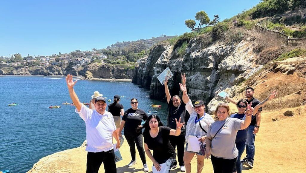 People on a cliff at the beach